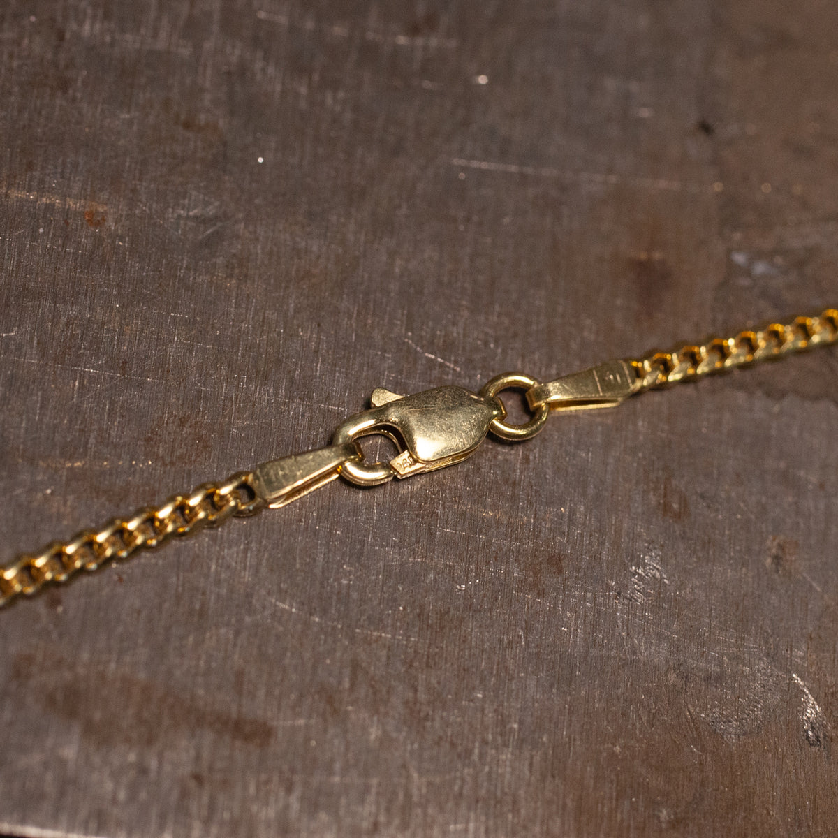 Fiat Lux Classic Cuban Chain (G) in 14K gold with a lobster claw clasp.