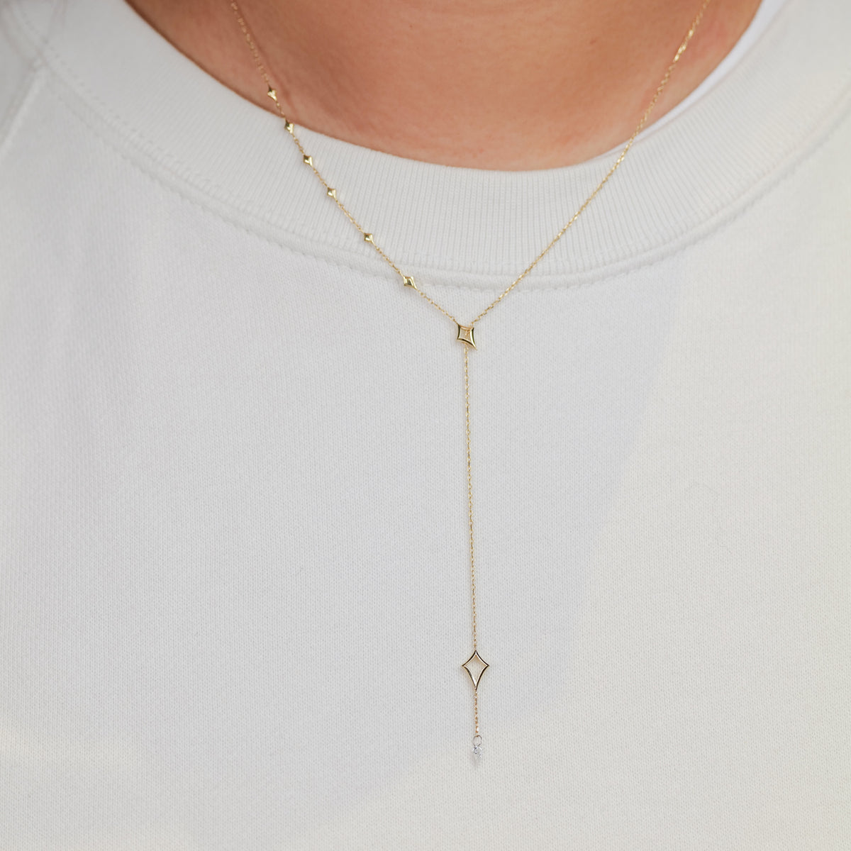 Fiat Lux North Star Lariat Necklace – White Diamond shines over a crew-neck, ideal for constellation jewelry fans.