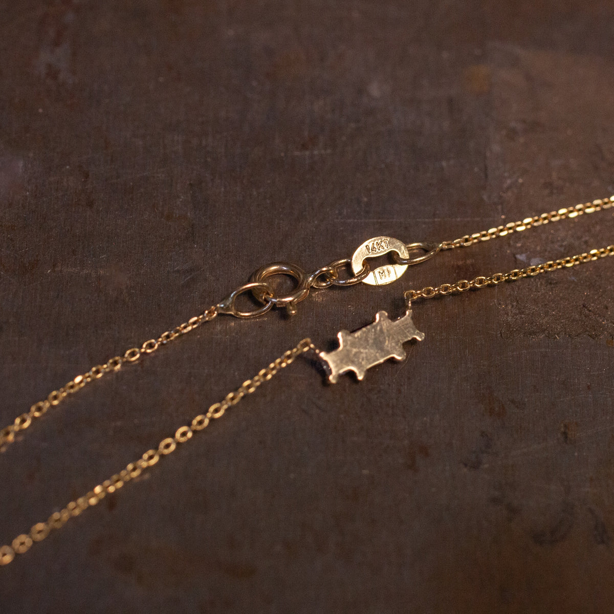 Grande Temple Necklace - Blue Sapphire: 14K gold chain with a small puzzle piece charm and a 14KT spring ring clasp.