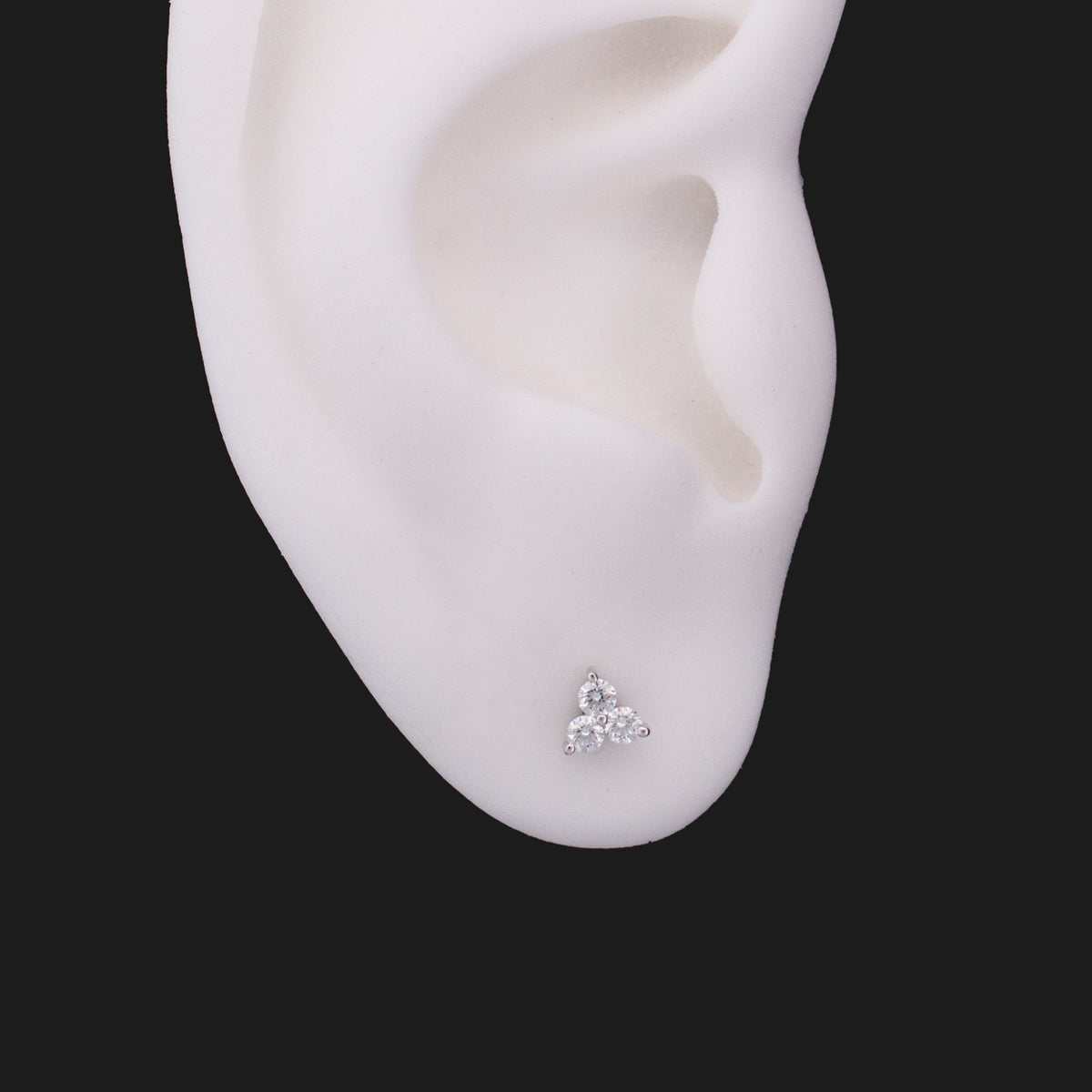 Fiat Lux 3 Gem Cluster - White Diamond (2mm) flatback labret on a white ear model.