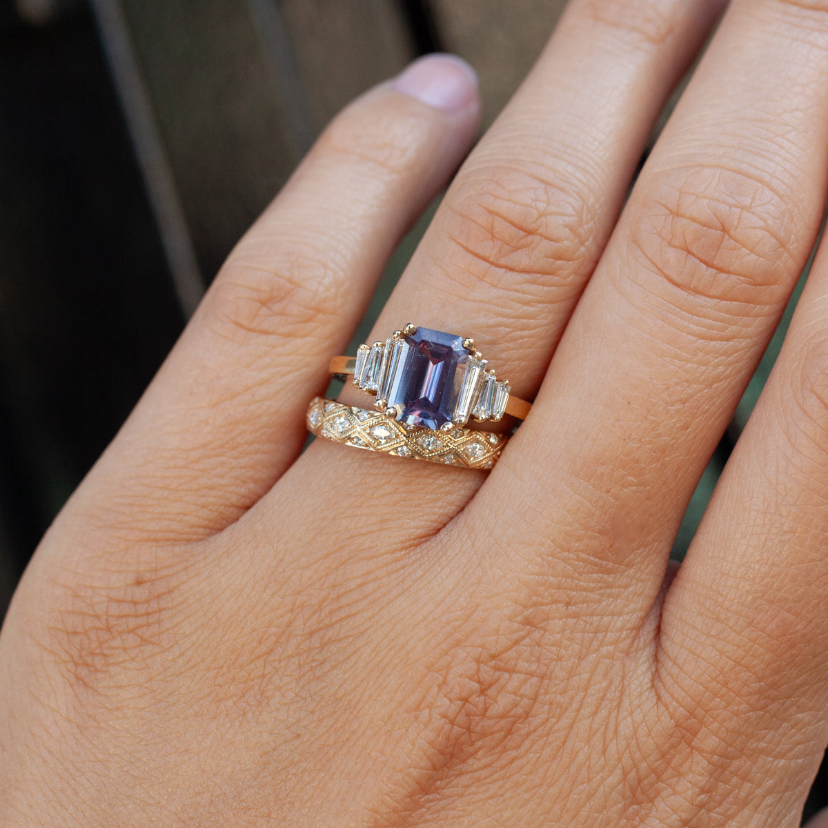 A finger wearing a Serpentra Ring - Marquise Diamond stacked with a patterned serpent ring.