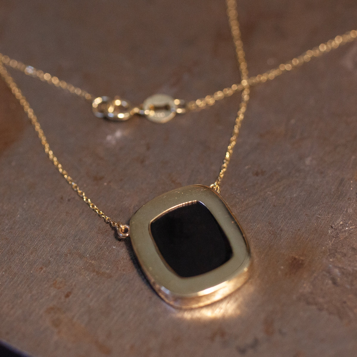 Ioanna Eleftheriou Heart Intaglio Necklace - Small Chain shown close-up; clasp and details visible in background.