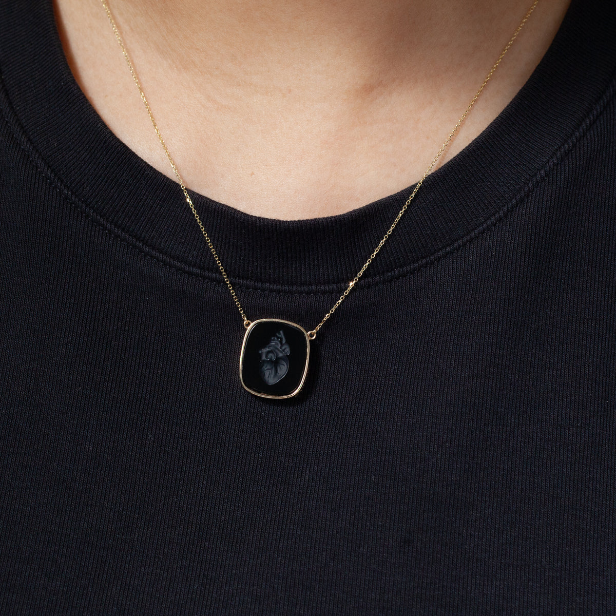 The Heart Intaglio Necklace by Ioanna Eleftheriou is perfect memory jewelry, chic over a black top.