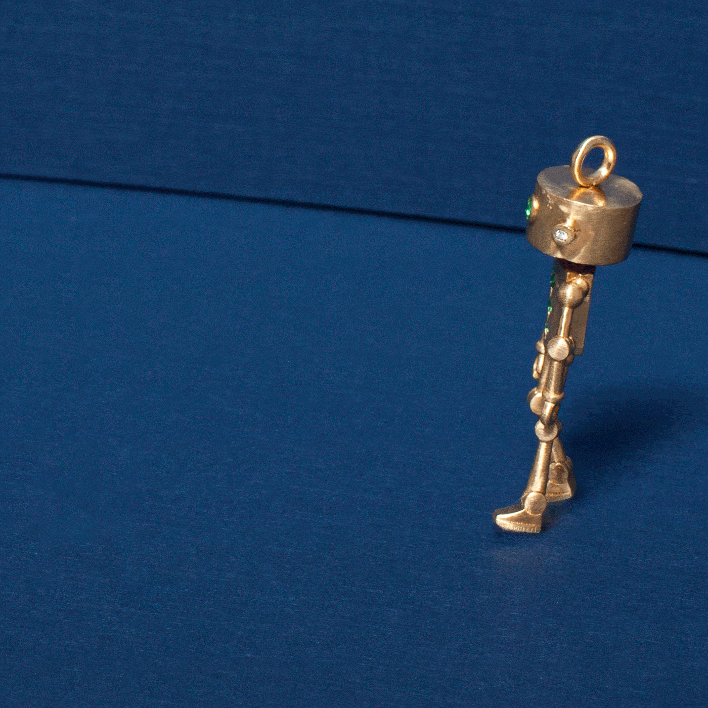Sparky the Robot Charm - Emerald: an 18k gold robot-shaped pendant with a small emerald accent eye.