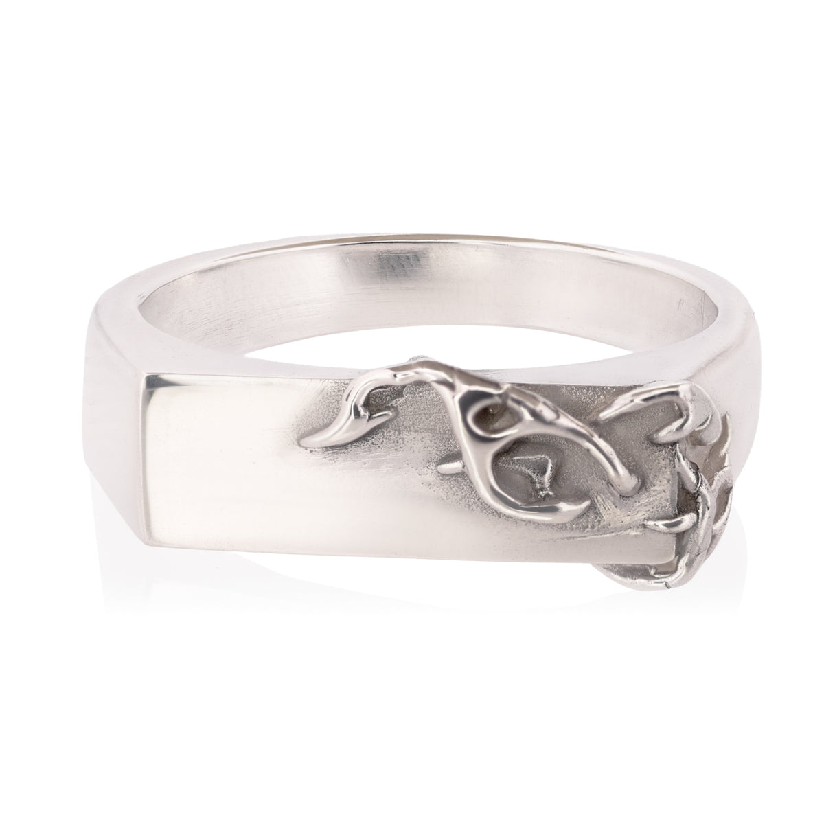 A silver signet-style ring with a flat rectangular face and an organic, textured branch-like overlay on the front, shown on a plain white background.