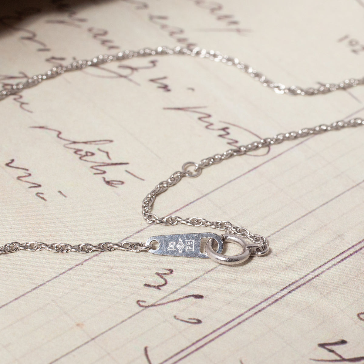 A silver-toned Vintage Platinum Rope Chain showing the clasp and a small rectangular hallmark tag.