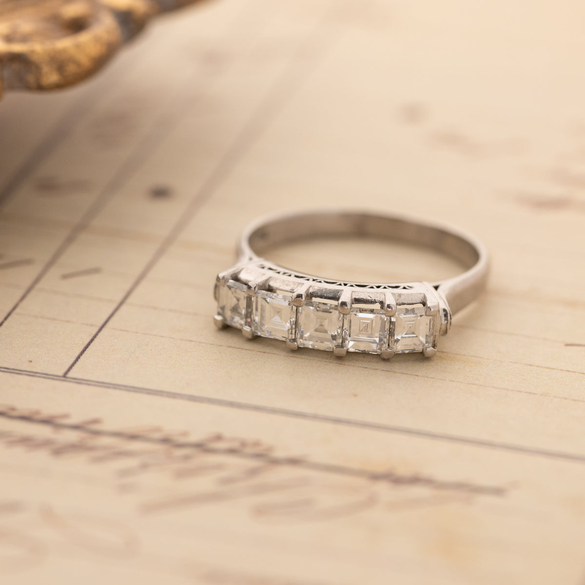 Vintage Carré Cut Diamond Band - 4.5mm platinum ring with five carré-cut diamonds and intricate side detailing.