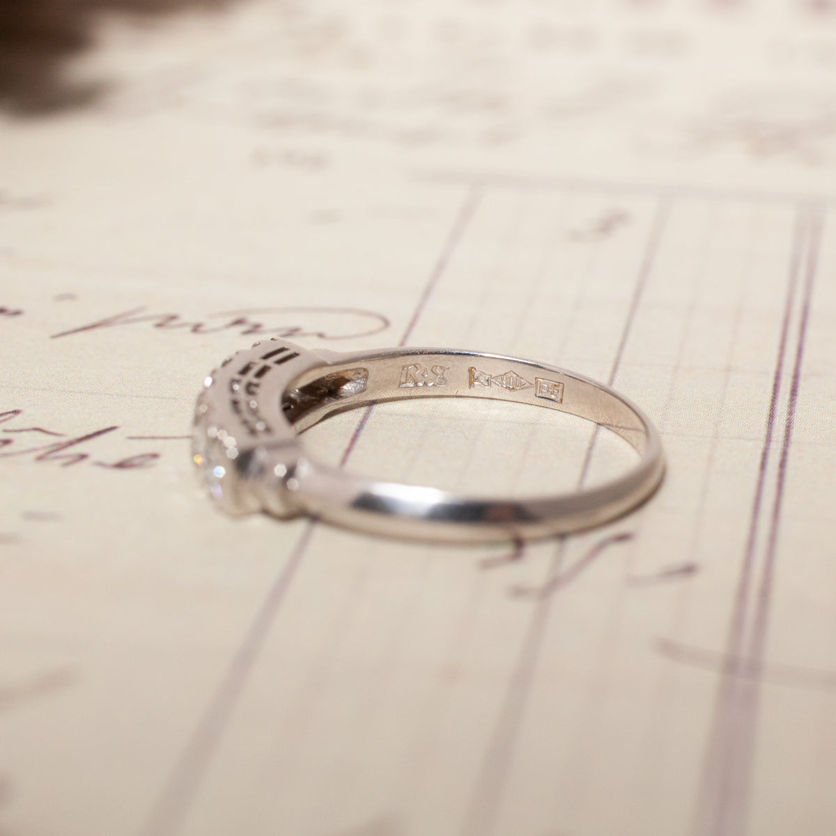 Side view of a Vintage Diamond Band Ring, showing hallmarks stamped on the inner platinum band.