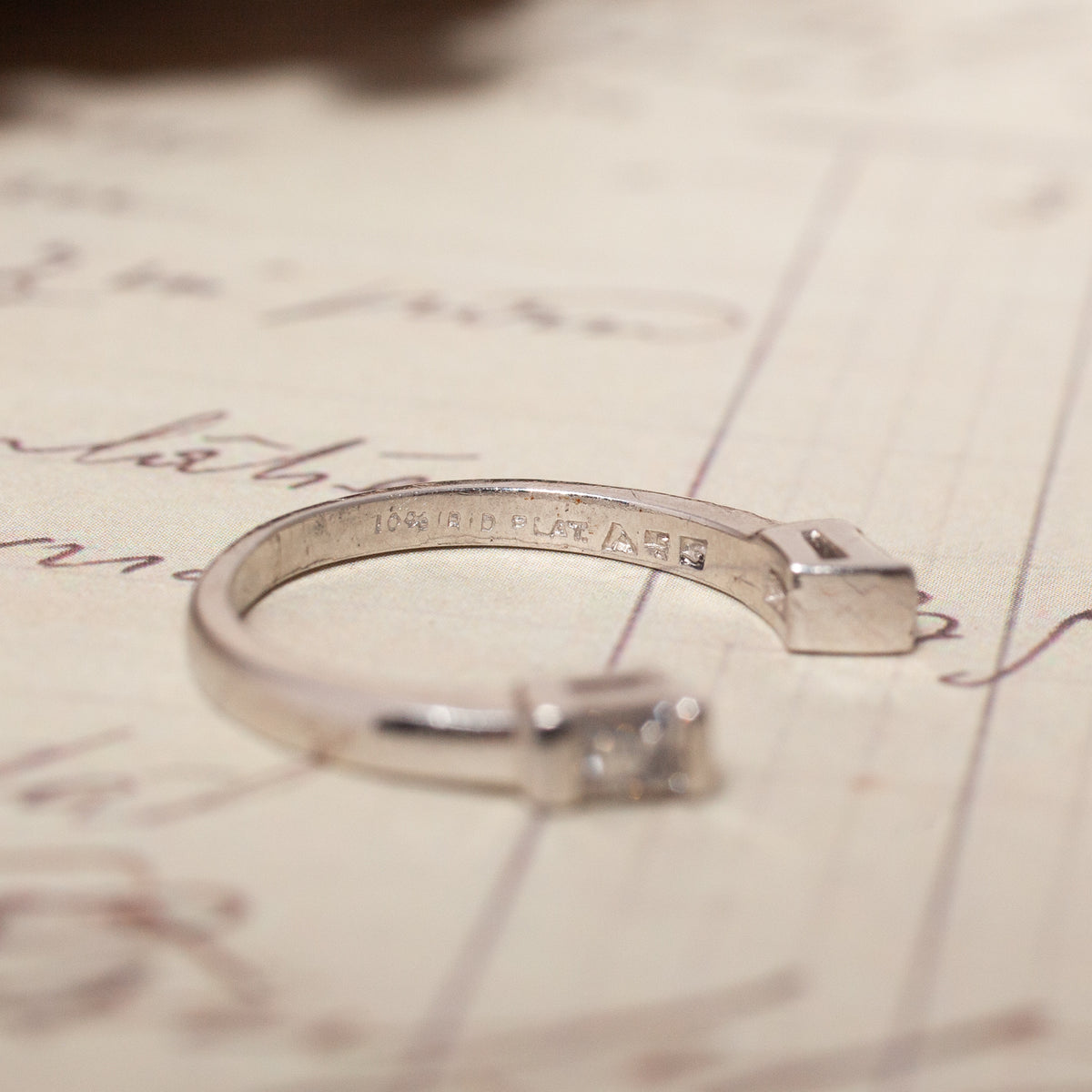 Vintage Open Baguette Diamond Band, an open-ended platinum ring with a baguette-cut diamond and inner band hallmarks.