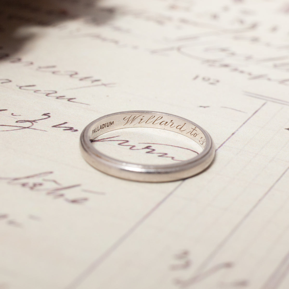 A silver-toned Vintage Palladium Band with PALLADIUM and Willard engraved on the inner surface.