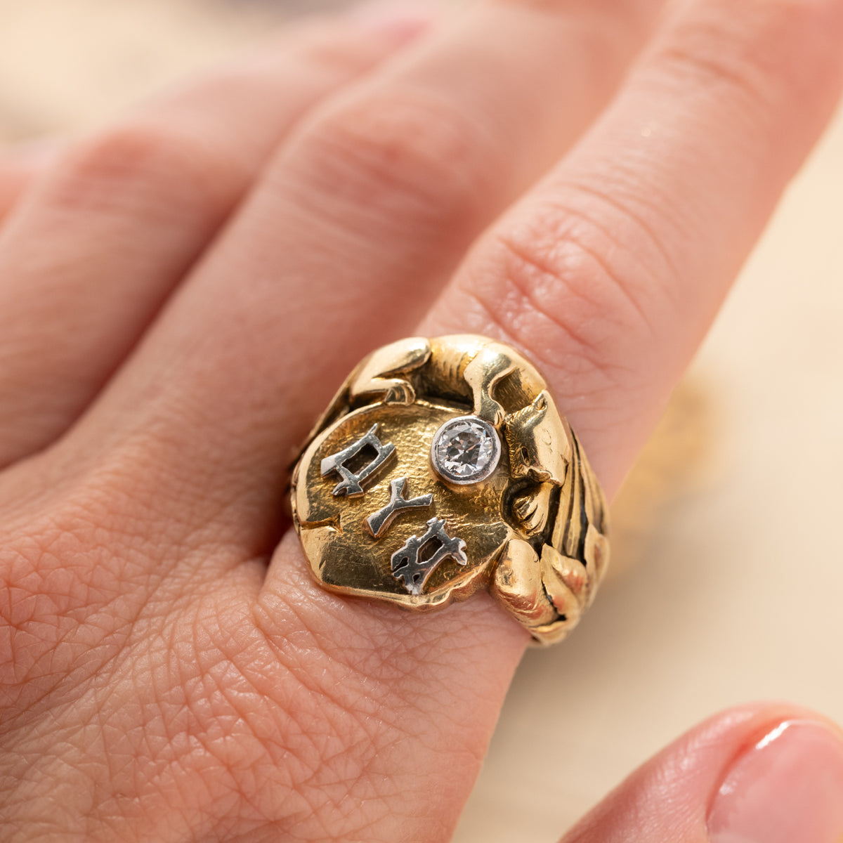 Vintage Panther with Diamond Heavy Signet ring in 14k gold with a panther head, a round diamond, and silver face lettering.