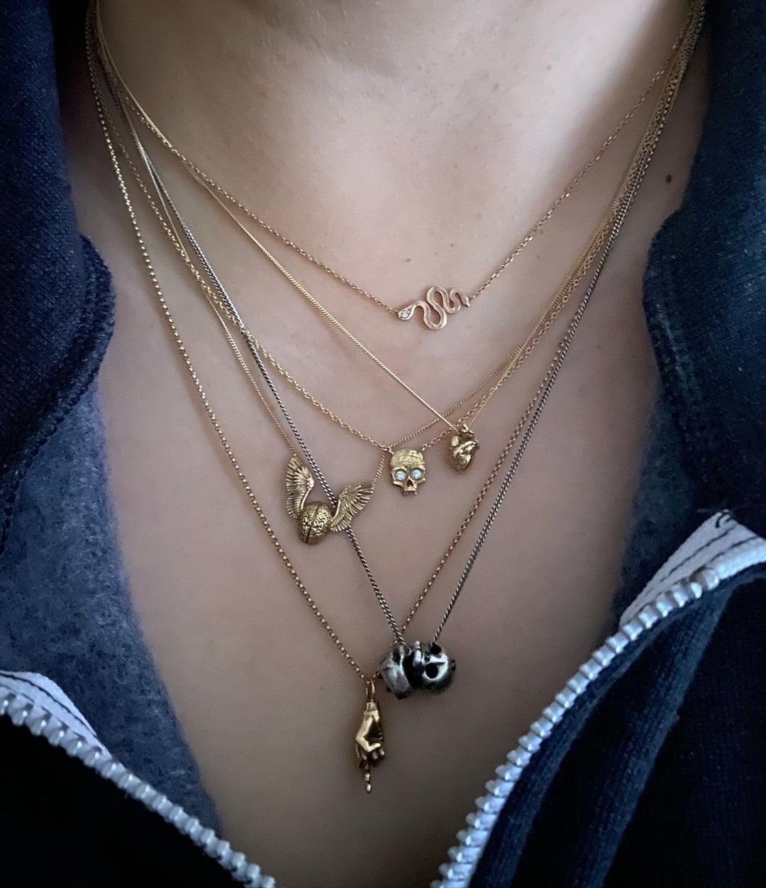 wing'd brain necklace by fiat lux sf in a six necklace stack alongside five other chains, pendants and necklaces