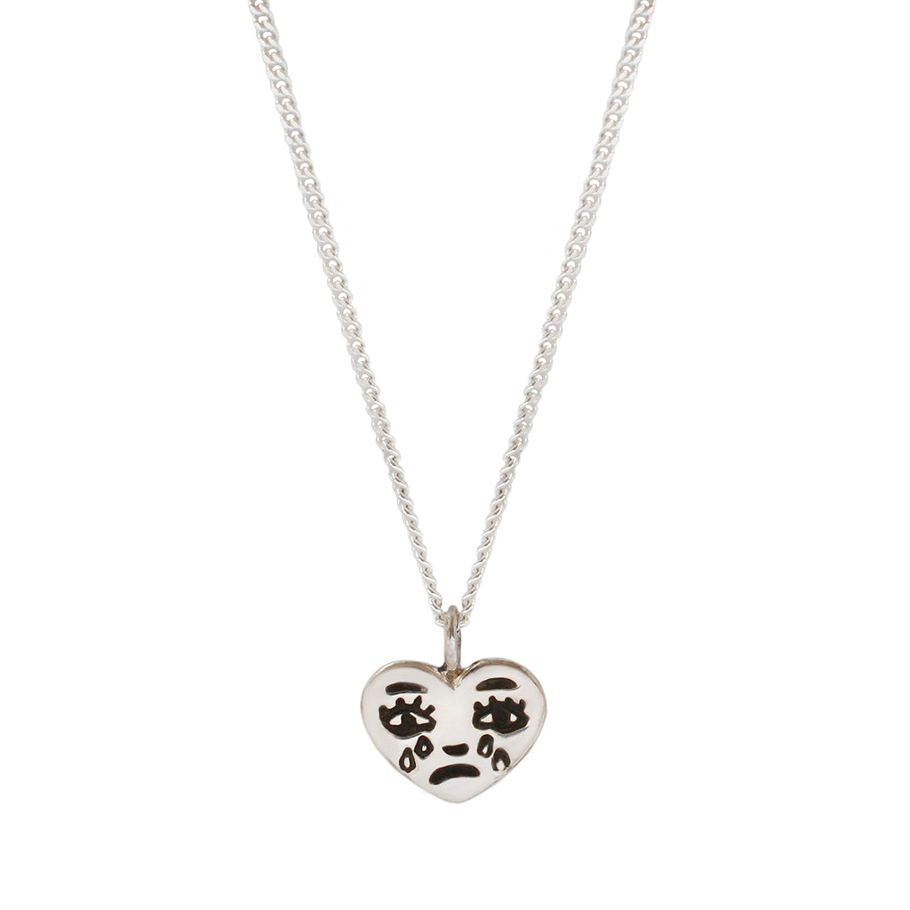 silver necklace with a crying heart