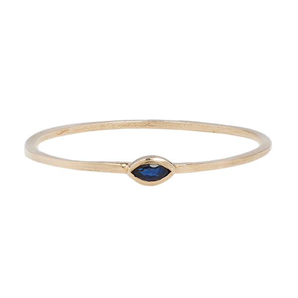 a yellow gold ring with a black diamond evil eye in the center is shown on a white background