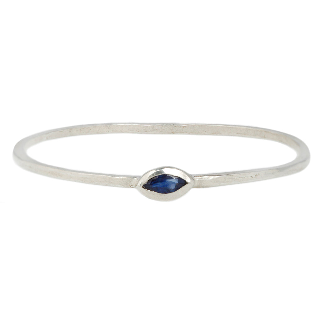 a sterling silver ring with a black diamond evil eye in the center is shown on a white background